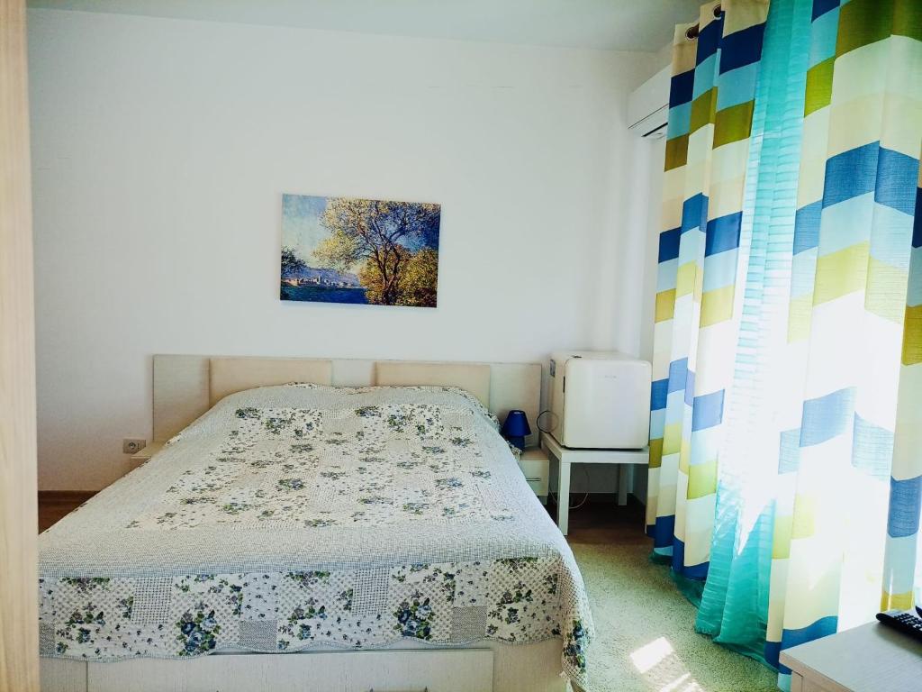 een slaapkamer met een bed en een schilderij aan de muur bij Casa Wave Sound in Agigea