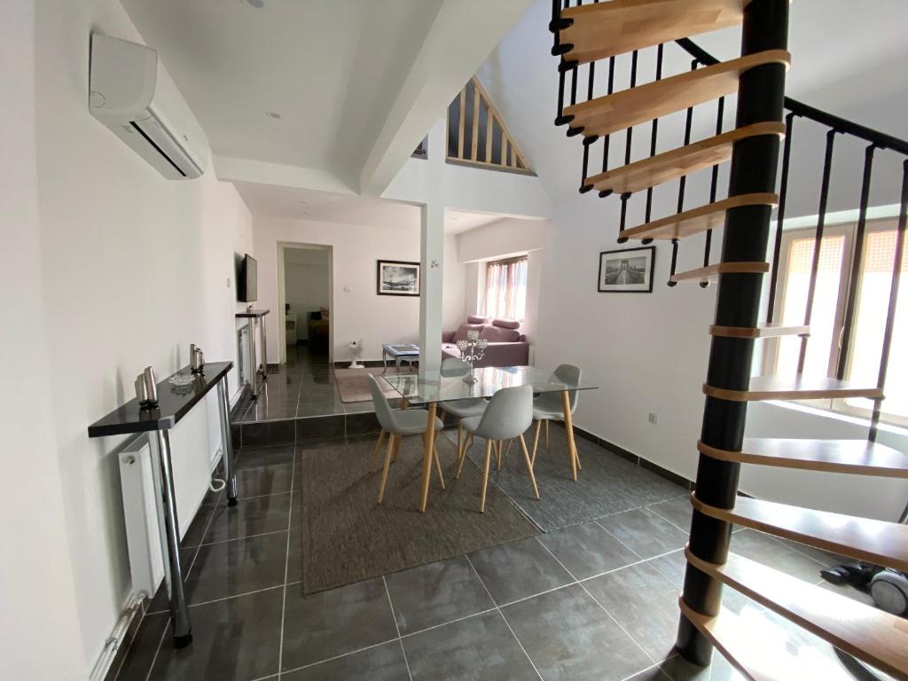 a dining room and living room with a table and chairs at Maison Wintzenheim in Wintzenheim