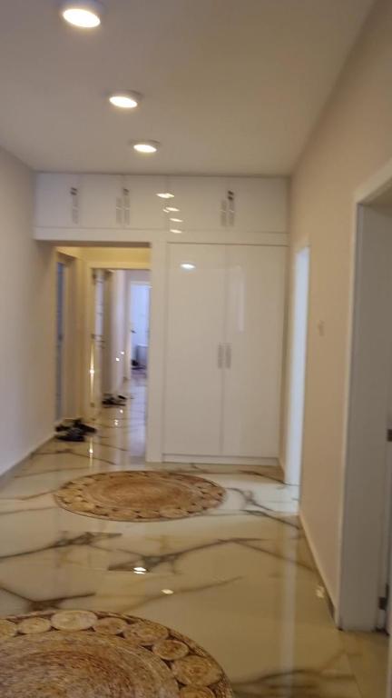 an empty room with a hallway with a large rug on the floor at Fawaz apt in Bursa