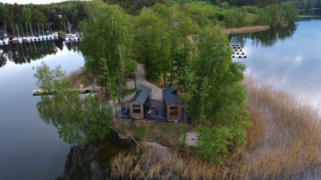 a house on an island in the middle of a lake at Tiny House - Osada Wilkasy in Giżycko