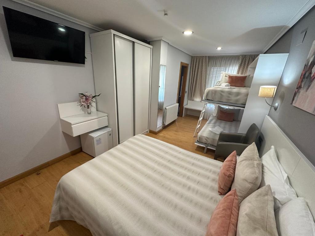 a hotel room with a bed and a television at Hotel Las Olas in Noja