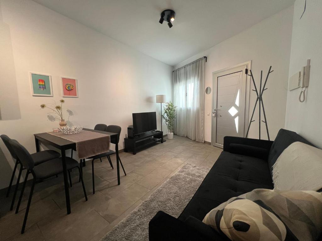 a living room with a couch and a table at Cozy apartment well-located in Terrassa, Barcelona in Terrassa