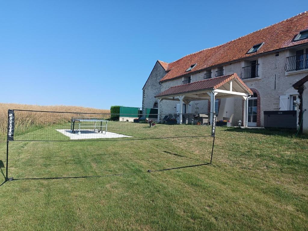 a large yard with a goal in front of a building at Chambre d'hôtes Le Domaine des Hirondelles in Champcenest