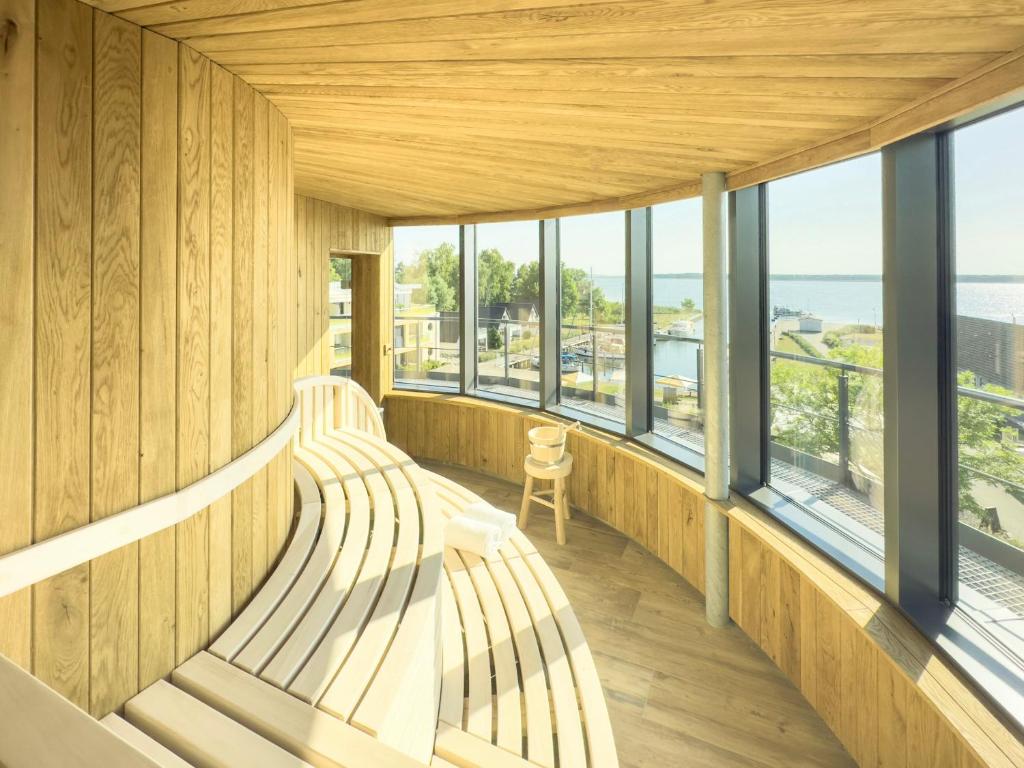 two benches in a room with windows at Appartements "Zum Leuchtturm" Hafen Rankwitz Insel Usedom in Rankwitz