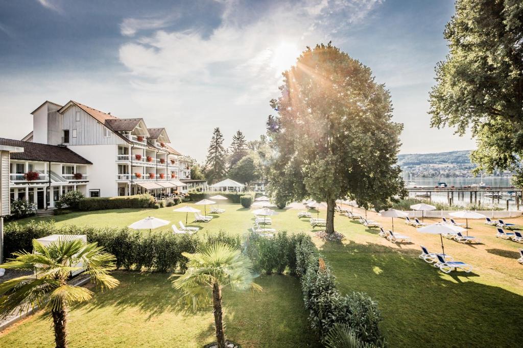 ein Resort mit Rasen und Palmen in der Unterkunft Hotel Hoeri am Bodensee in Gaienhofen