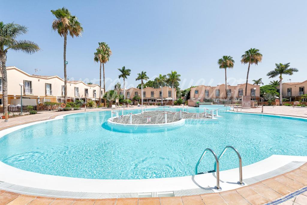a large swimming pool with a fountain at Sweet Holidays in Maspalomas