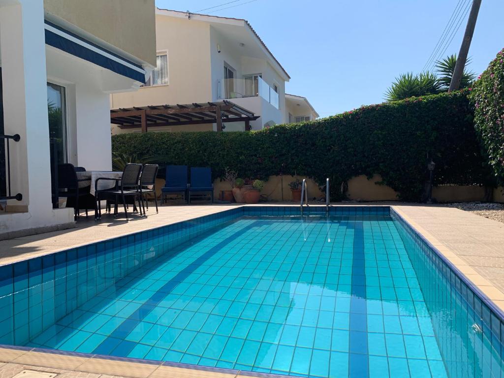 a swimming pool in front of a house at Holiday Home Emba in Emba