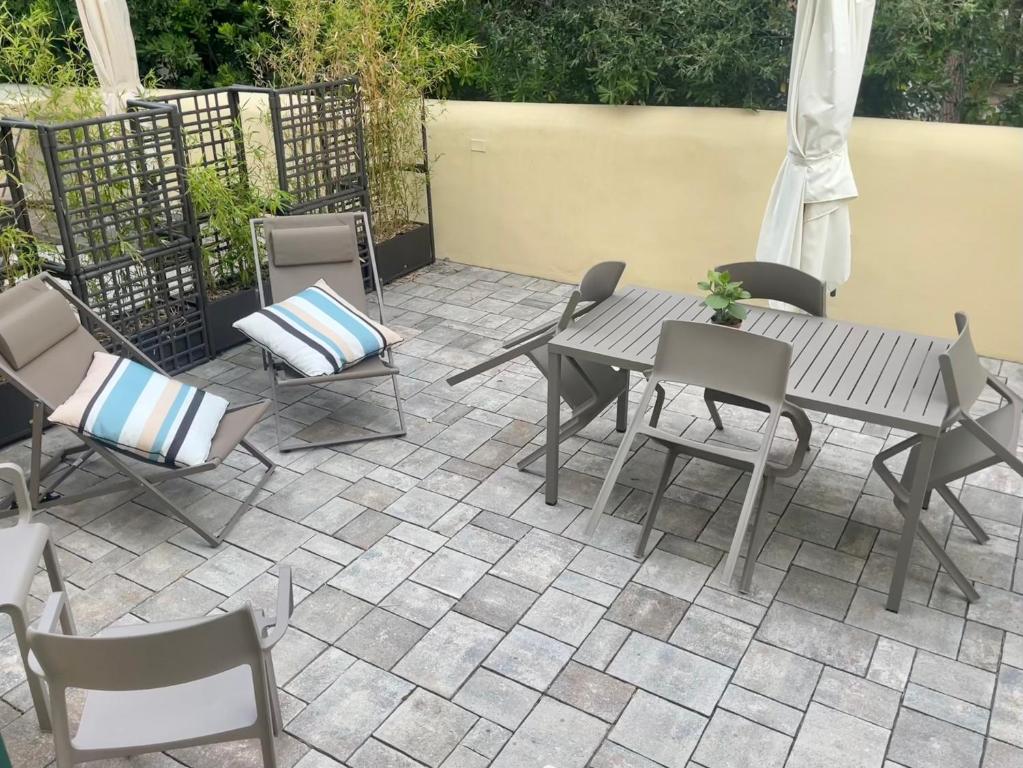 a patio with a table and chairs on a patio at Via Zug in Castiglioncello