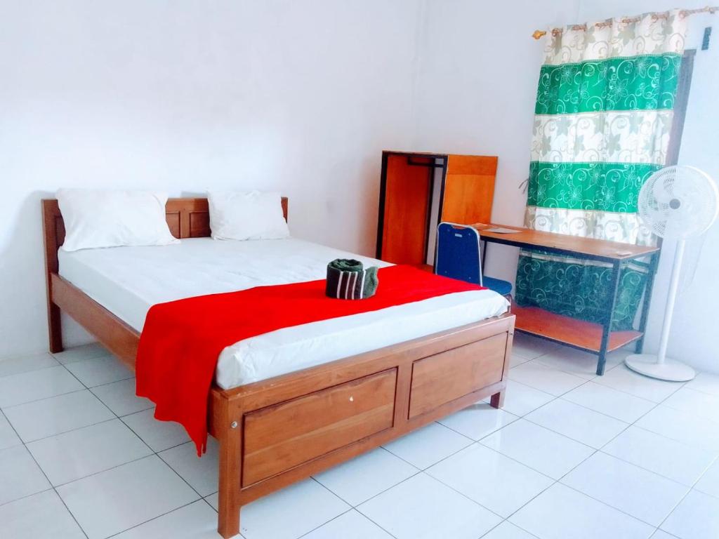 A bed or beds in a room at Flores One Love Homestay