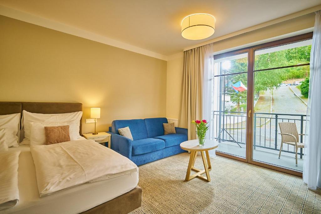 Postel nebo postele na pokoji v ubytování Wellness Hotel Queens