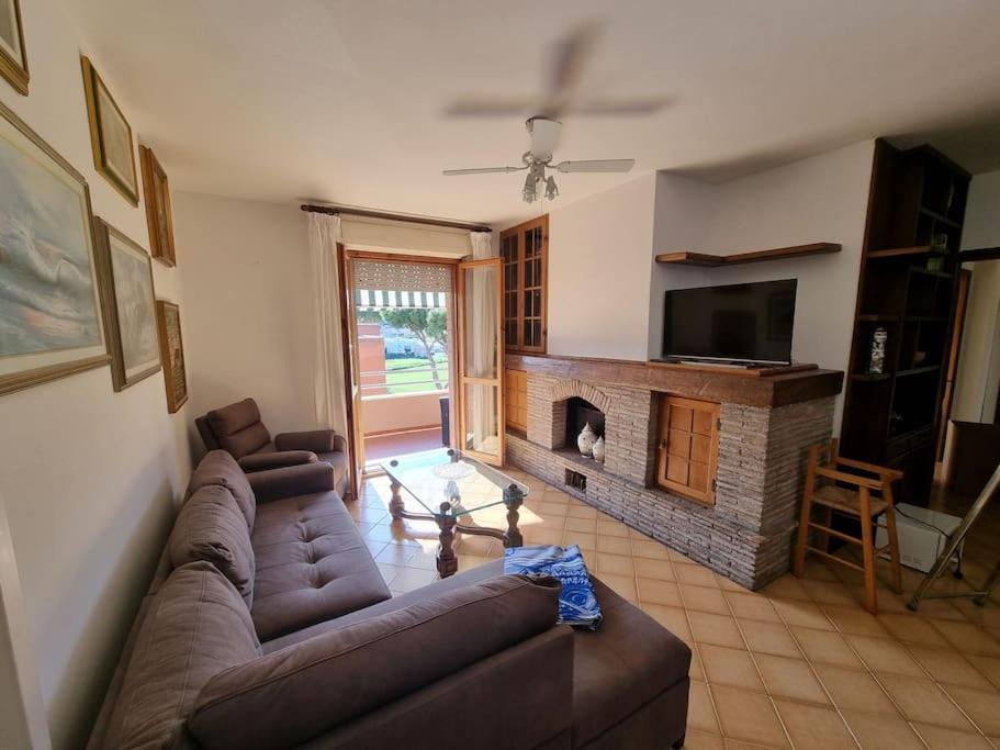 a living room with a couch and a fireplace at Casa Bortoli in Castiglione della Pescaia