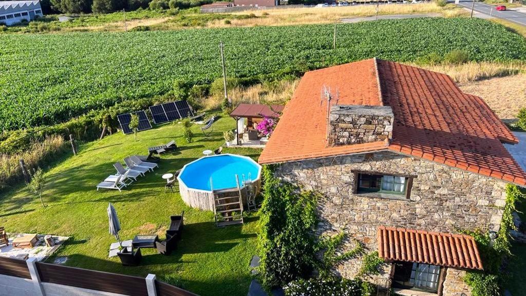 an aerial view of a house with a swimming pool at Camiño da Vieira in Padrón