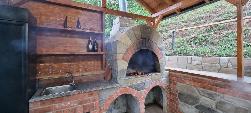 a brick oven with a sink and a kitchen at Chateau Maxuntseti in K'veda Bzubzu