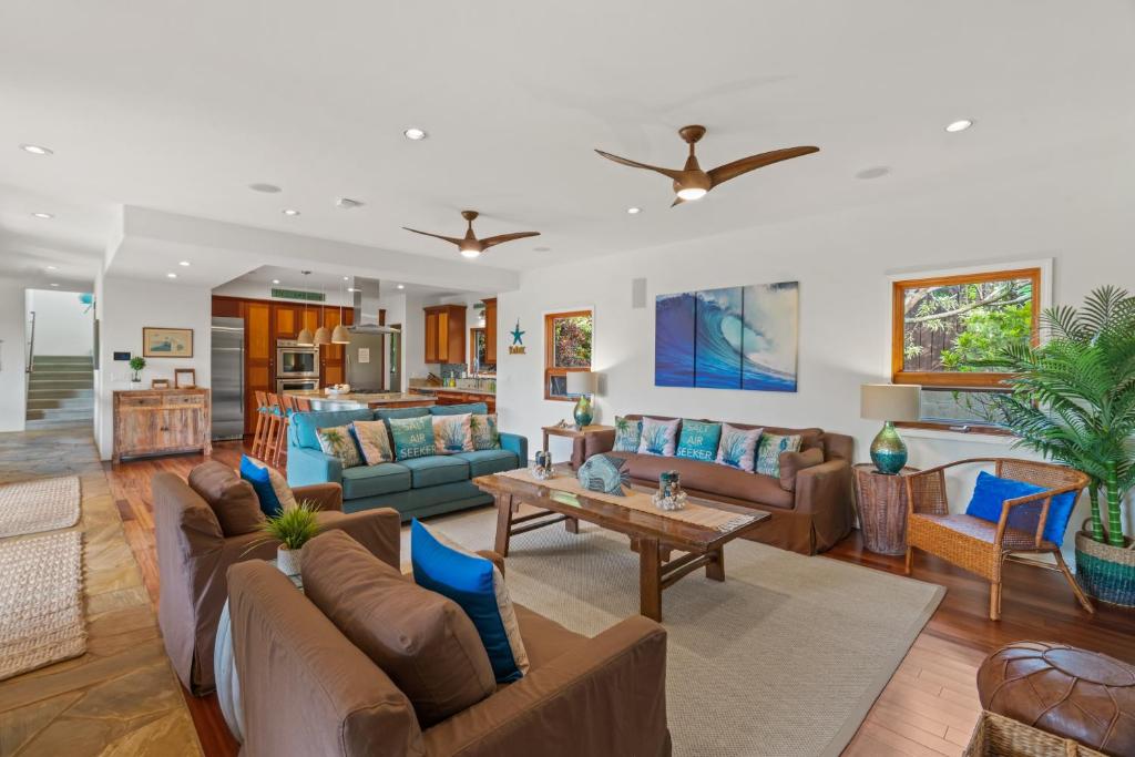 a living room with couches and a table at Custom 4br Home Walking Distance to Beach - Alekona Kauai in Koloa