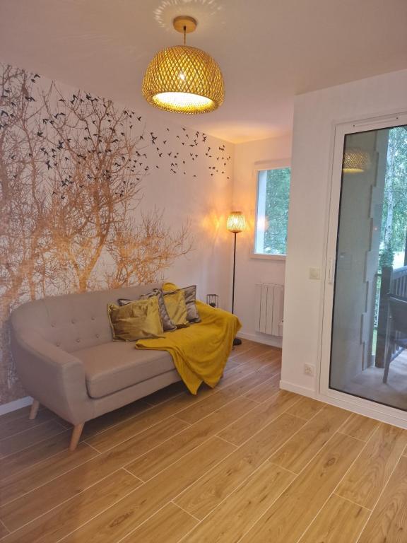 un salon avec un canapé et une lampe dans l'établissement Appart 2 chambres Piscine chez ROX - Résidence du Golf, à Deauville