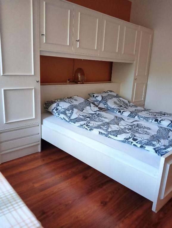 a bedroom with a bed with a white bed frame at Mieszkanie nad Szeszupą 16-406 Rutka-Tartak ul, 3 go Maja 1 in Rutka Tartak