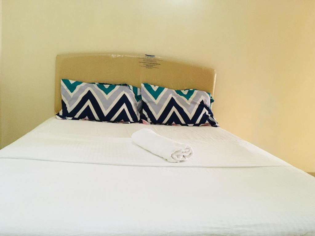 um close-up de uma cama com uma almofada branca em Amazing view studio apt shared with the host em Nairobi