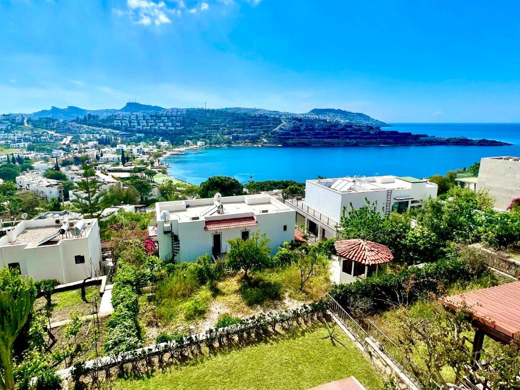 a house on a hill with a view of the ocean at Seaview Grand - MAGIC Gundogan in Bodrum City