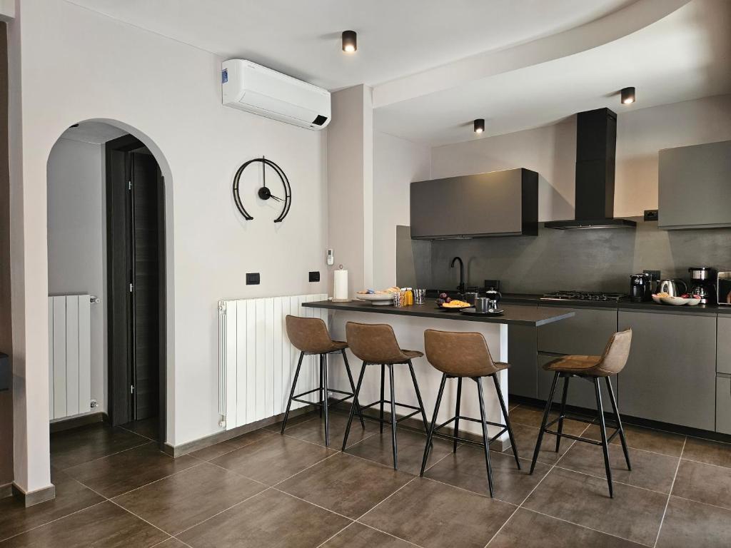 a kitchen with a counter and stools in it at Al Dolce Vita in Stresa