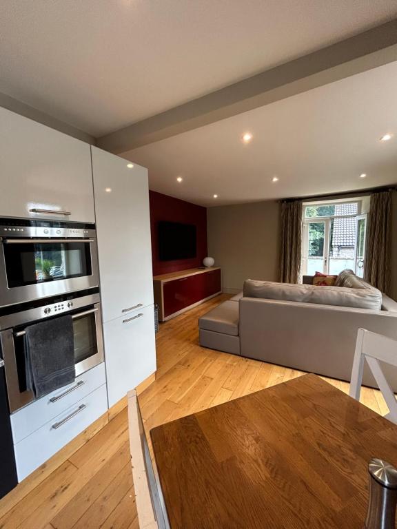 a large living room with a couch and a kitchen at Luxury Apartment - Great Location in Ecclesall