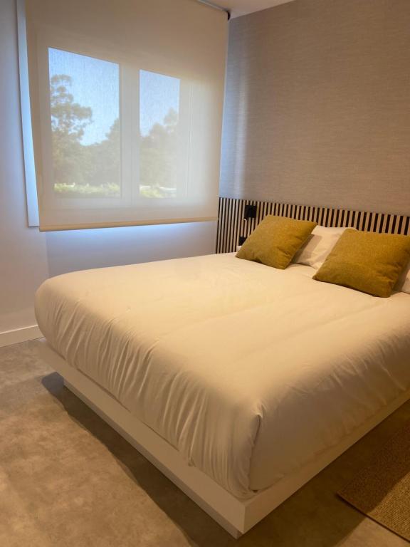 Postel nebo postele na pokoji v ubytování Apartamentos Forxán