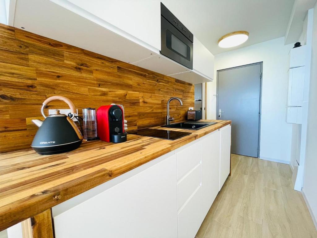 a kitchen with a counter with a tea kettle on it at Studio FRONT DE MER rénové in Le Barcarès