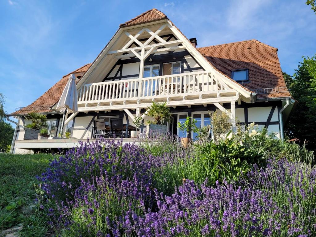 a house with purple flowers in front of it at Romantik-Suite Nordelsaß B&B in Oberhoffen-lès-Wissembourg