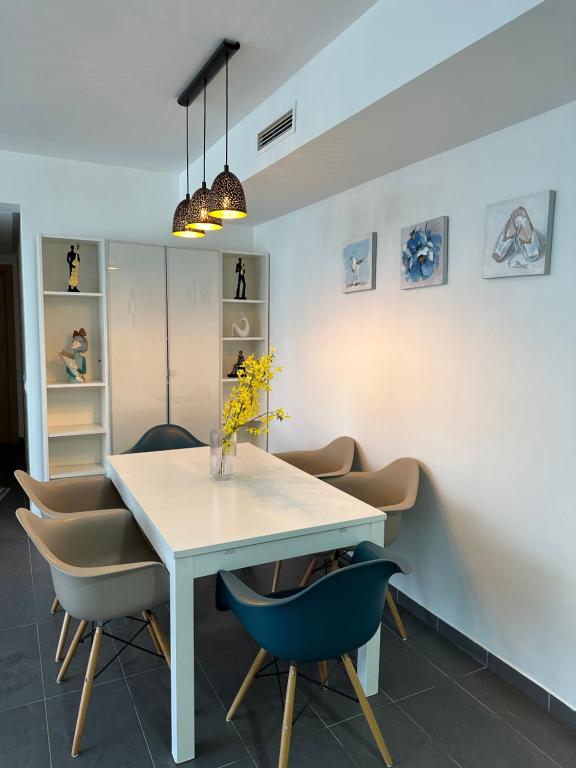 comedor con mesa blanca y sillas en luxury apartment in City Center Hilton en Tánger