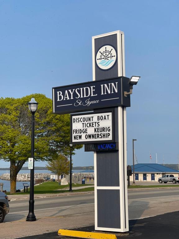 a sign for the bayside inn on a street at Bayside Inn in Saint Ignace