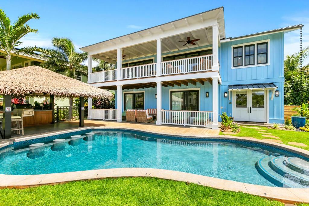a house with a swimming pool in front of a house at 4BR Poipu Home with Private Pool- Alekona Kauai in Koloa