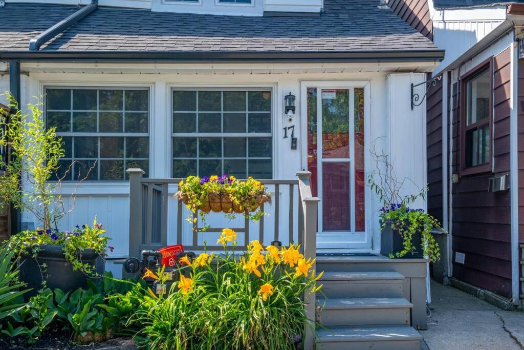 a front door of a house with flowers and a porch at Charming Beach Retreat in Toronto