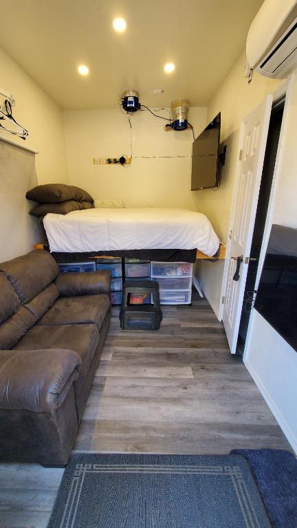 a small living room with a couch and a bed at 1 Bedroom Mini Apartment in Otay Ranch in Chula Vista