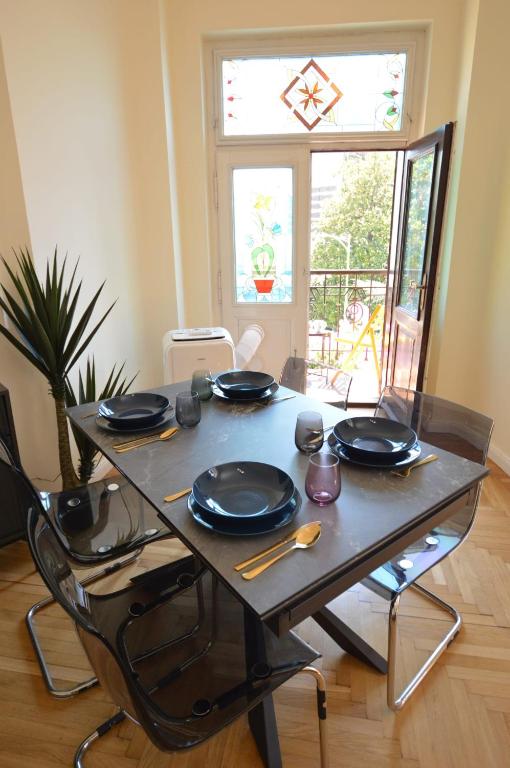 a table with black plates and utensils on it at Romeo&amp;Juliet in Opatija