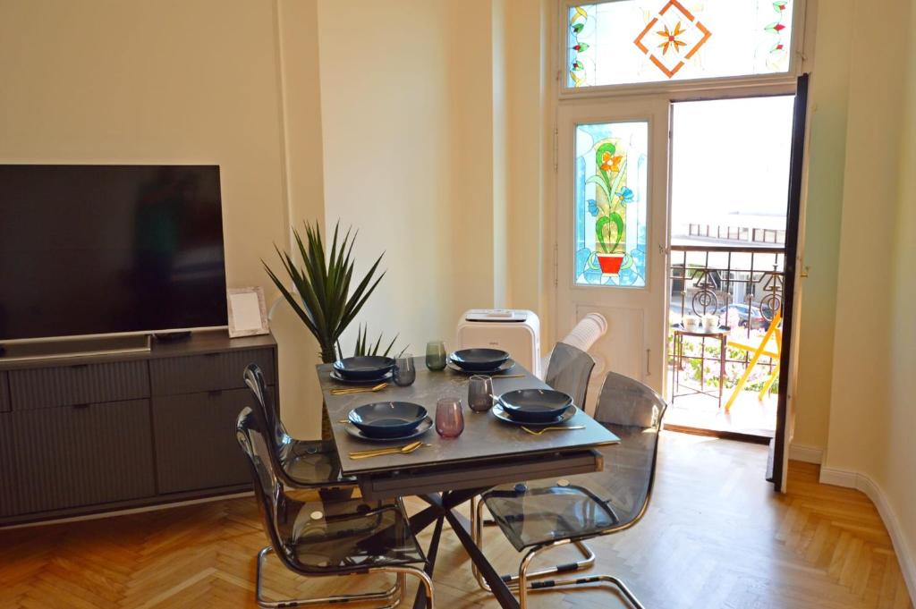 a dining room with a table with chairs and a television at Romeo&amp;Juliet in Opatija