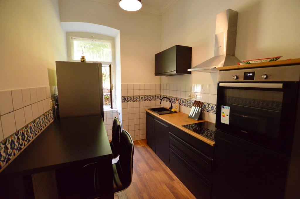 a kitchen with a black counter and a sink at Romeo&amp;Juliet in Opatija