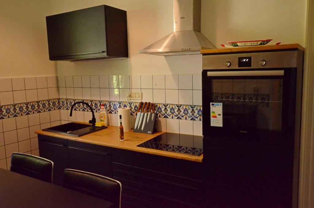 a kitchen with a sink and a stove top oven at Romeo&amp;Juliet in Opatija
