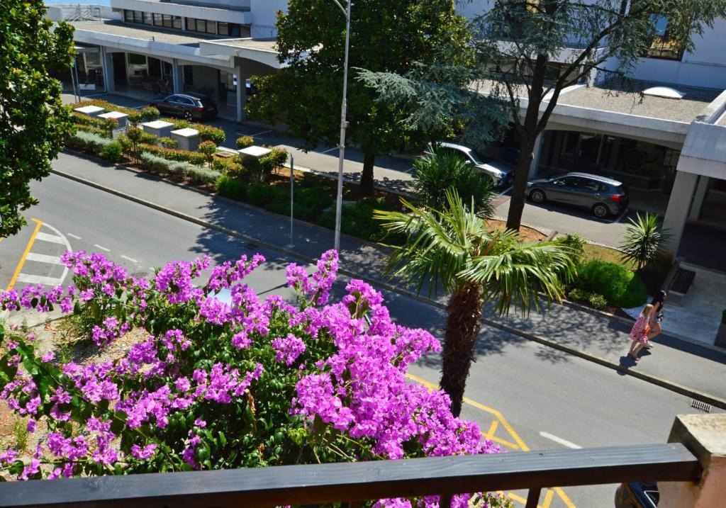 a view of a city street with purple flowers at Romeo&amp;Juliet in Opatija
