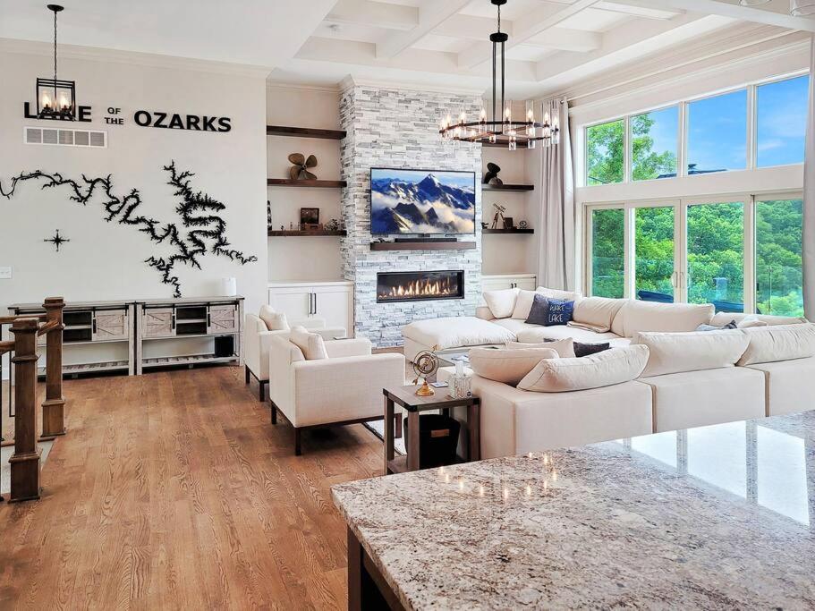 a living room with white furniture and a fireplace at Magazine-Featured Mansion, Golf Green, Casino, etc in Sunrise Beach