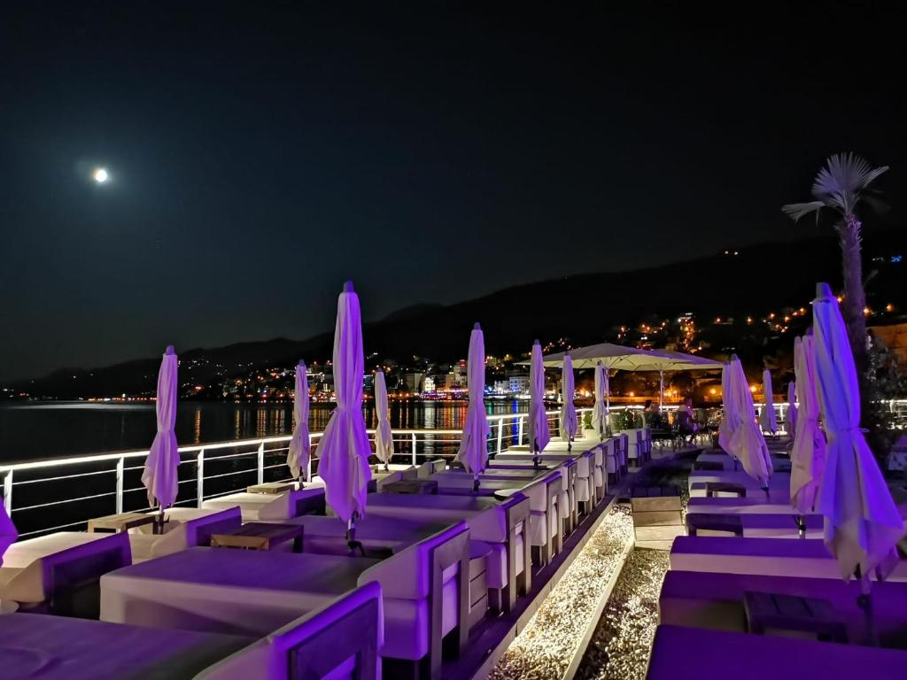 a row of purple chairs and umbrellas at night at Romeo&amp;Juliet in Opatija