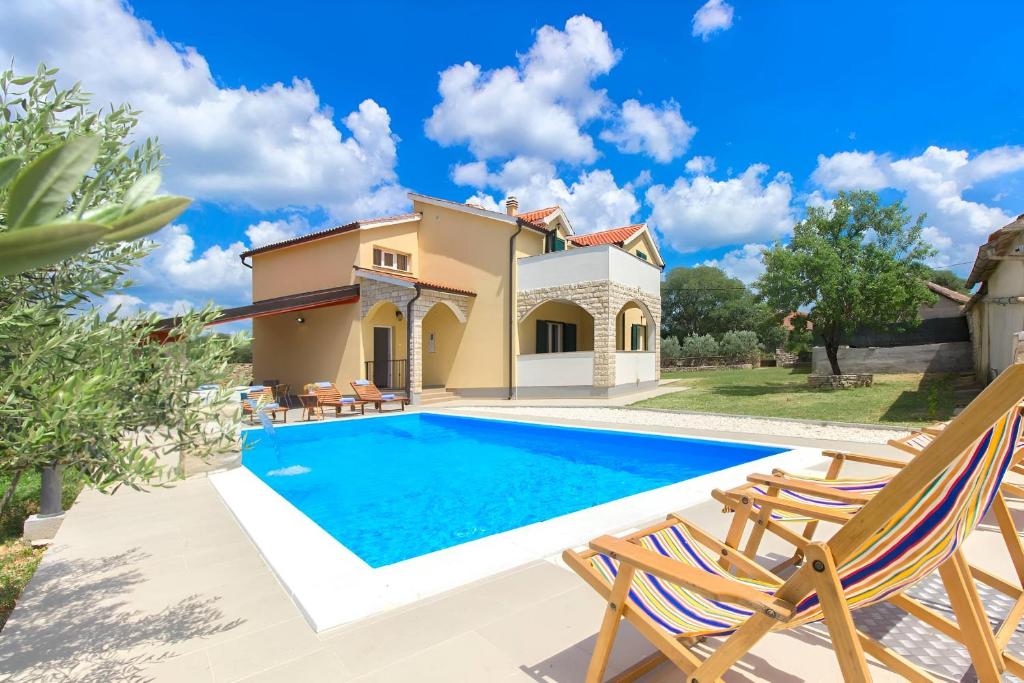 une villa avec une piscine et une maison dans l'établissement Villa Oasis near Krka Waterfalls, à Drniš