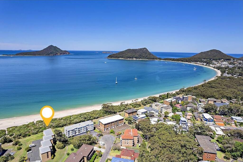 an aerial view of a beach with houses and the ocean at 'Serenity Now' Shoal Bay Beach Front with All Linen, WiFi and Air Con in Nelson Bay