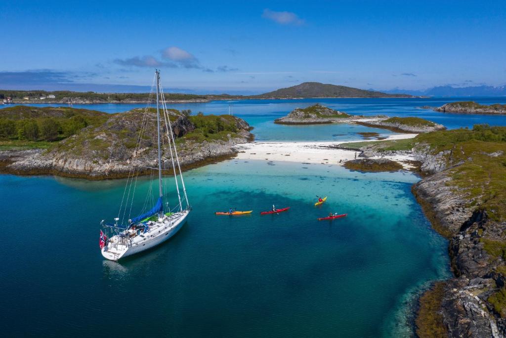 an aerial view of a sailboat in a body of water at Liveaboard sailing tour in Harstad islands in Harstad