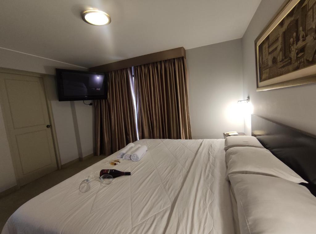 Postel nebo postele na pokoji v ubytování Inti Llaqta Hotel & Suites