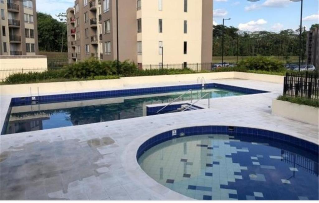 a swimming pool in the middle of a building at La Katiritaa in Villavicencio