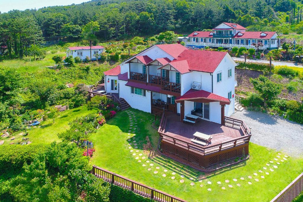 an aerial view of a large house with a yard at Travel Sketch Pension in Geoje