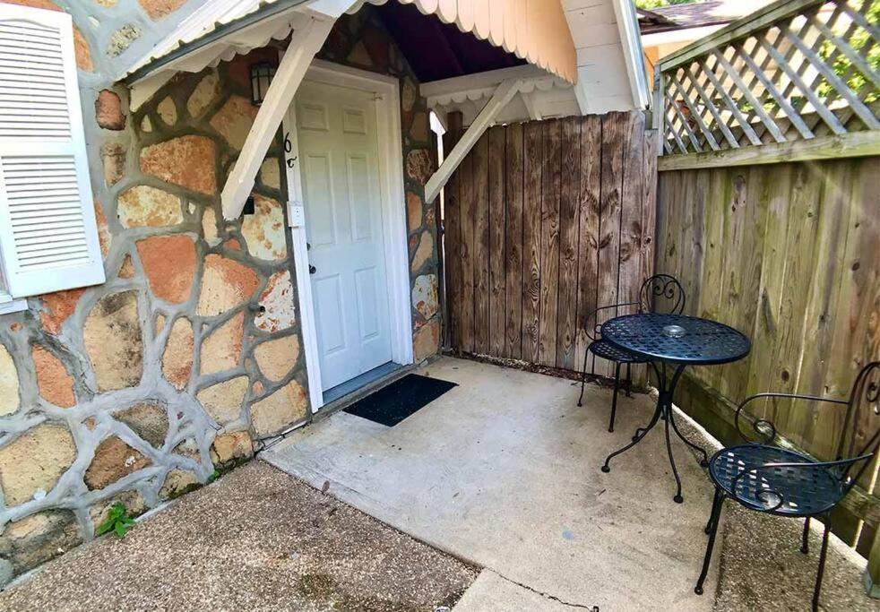 a patio with a table and chairs in front of a door at D'vinery Rock Cottage/ #6 in Eureka Springs