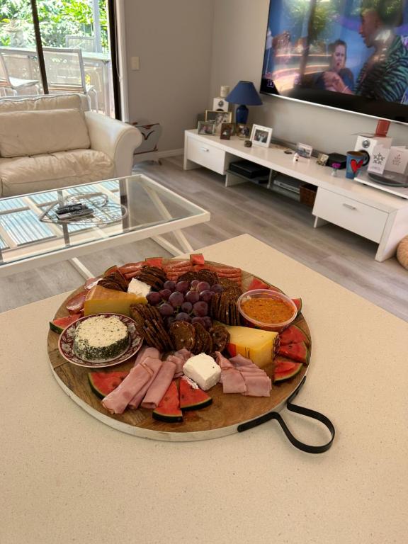 a plate of food on a table in a living room at Mermaid Waters 3 Bedroom Home Free Wifi - Close to the beach - shops in Gold Coast