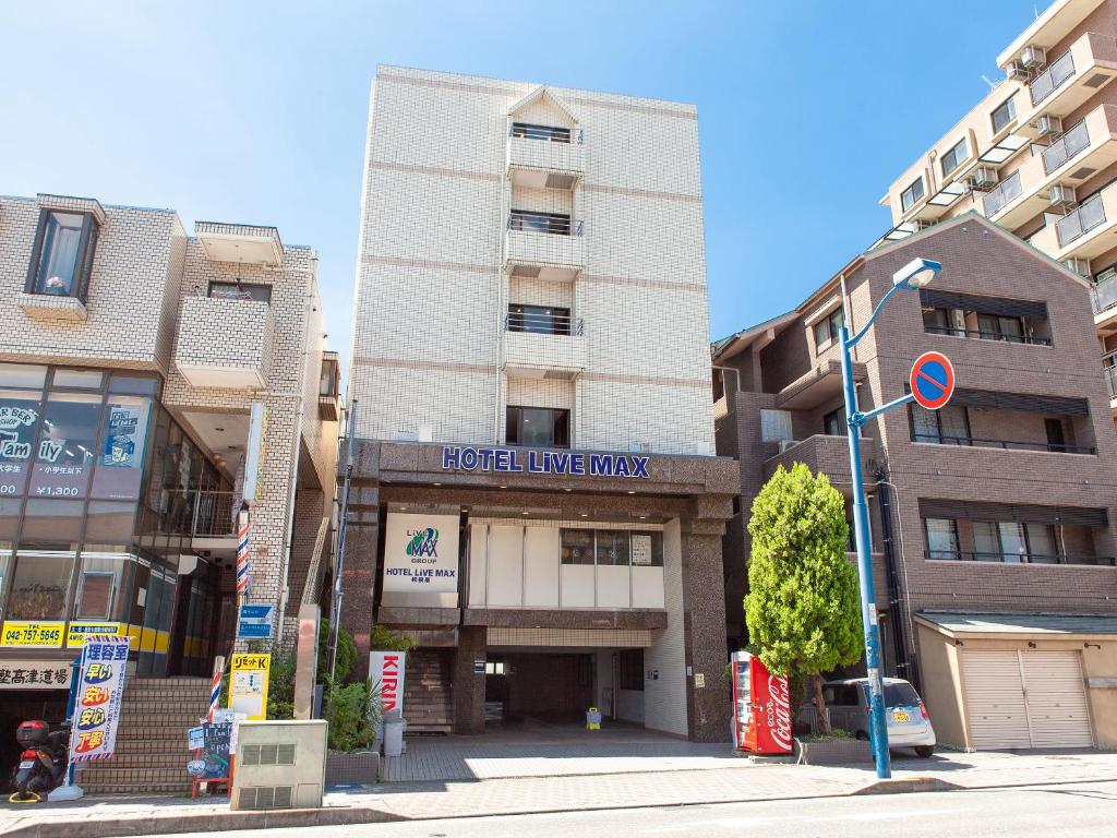 un edificio con un cartello sulla parte anteriore di HOTEL LiVEMAX BUDGET Sagamihara a Sagamihara