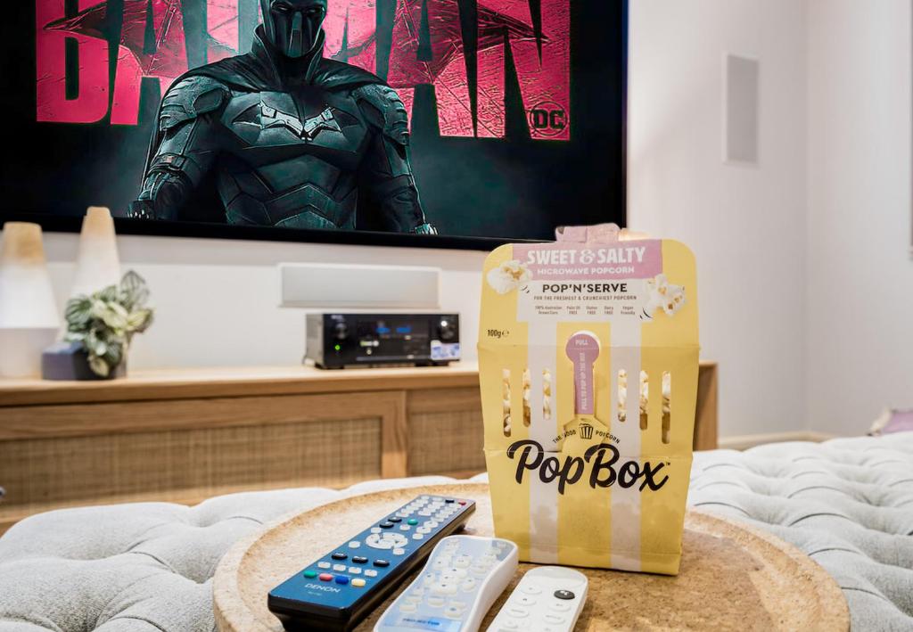 a table with a box and remote controls on it at The Tranquil Retreat in Safety Beach