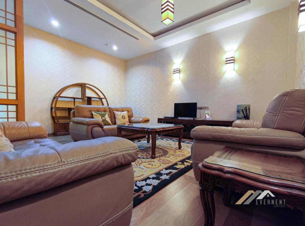 a living room with couches and a table at Mciti Suites by Evernent in Miri